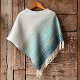 Tirkīzzila toņa īsais/pusgarais aitas vilnas pončo ar baltām bārkstīm