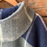 Klasiskas rūtis tumši zilos/piparmētru zaļos/maigi rozā toņos indiāņu piegriezuma garais aitas vilnas pončo ar kapuci un bārkstīm