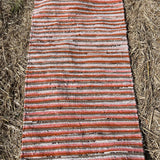 Oranžas, gaiši pelēkas, brūnas svītriņas, vilnas auduma grīdceliņš ~70x130cm